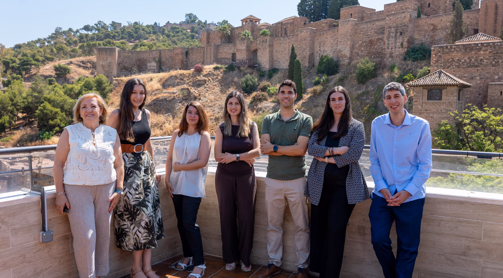 Equipo de Buenaley en la terraza, con la Alcazaba de Málaga al fondo